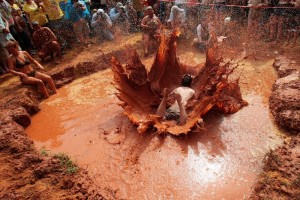 A red-clay spray showers spectators at the mud-pit belly flop, highlight of the annual Summer Redneck Games.